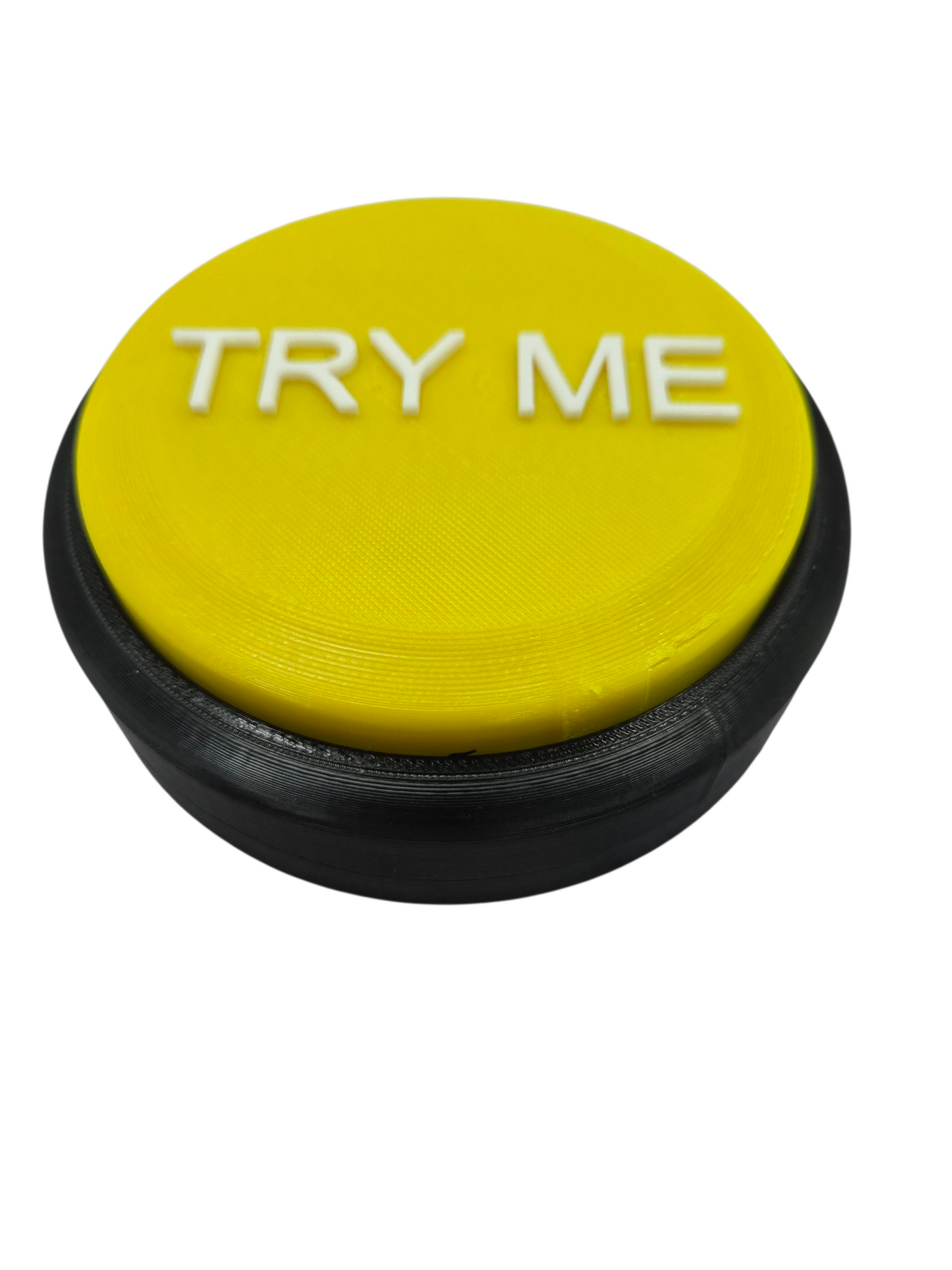 Yellow 3D printed Try Me animatronic step pad button trigger switch close-up on white background